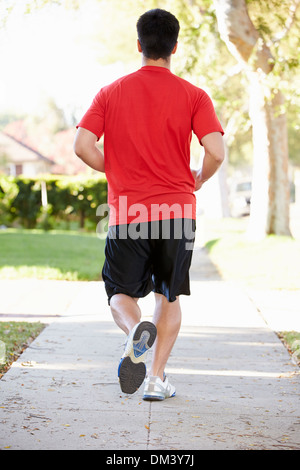 Male Runner Exercising On Suburban Street Stock Photo - Alamy