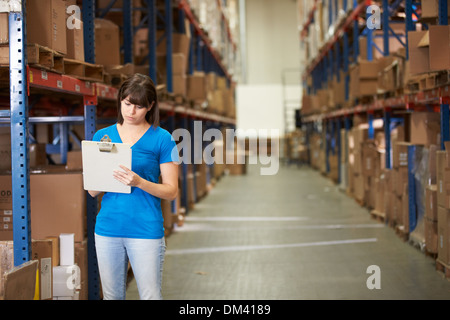 Female Worker In Distribution Warehouse Stock Photo