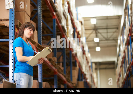 Female Worker In Distribution Warehouse Stock Photo