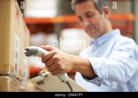 Worker Scanning Package In Warehouse Stock Photo