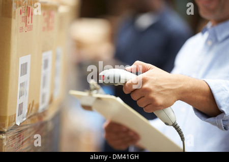 Worker Scanning Package In Warehouse Stock Photo