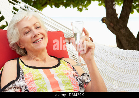 Senior Woman Relaxing In Hammock Stock Photo - Alamy