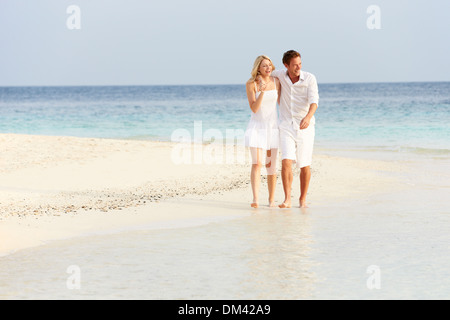 Romantic Couple Walking On Beautiful Tropical Beach Stock Photo