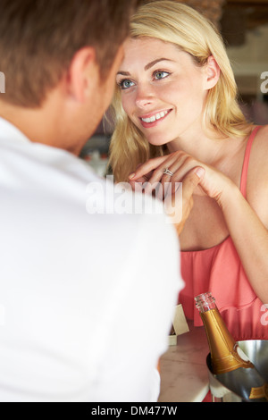 Man Proposing To Woman In Restaurant Stock Photo