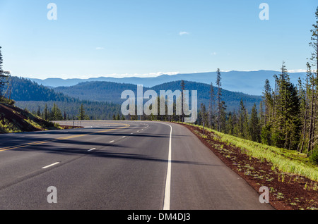 Highway curving through a dramatic nature scene in Central Oregon Stock Photo