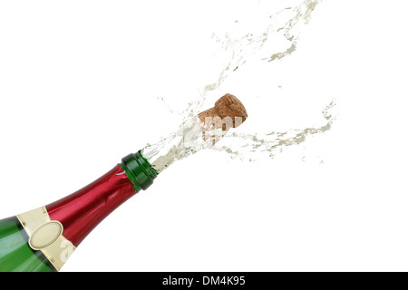Champagne splashing out of the bottle with a popping cork on New Year's Eve or party Stock Photo