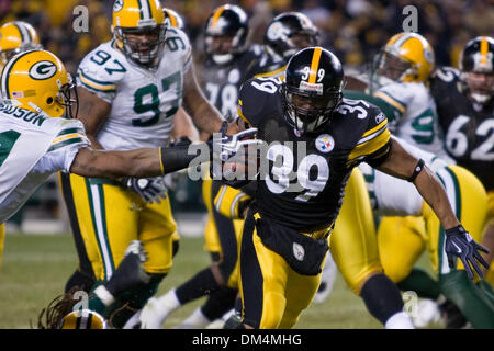 20 December 2009:  Green Bay Packers Charles Woodson (21) reaches for the football as Pittsburgh Steelers Willie Parker (39) runs past during the NFL football game between the Green Bay Packers and the Pittsburgh Steelers at Heinz Field in Pittsburgh, Pennsylvania.  The Steelers scored the game-winning touchdown as time expired to defeat the Packers 37-36..Mandatory Credit - Frank  Stock Photo