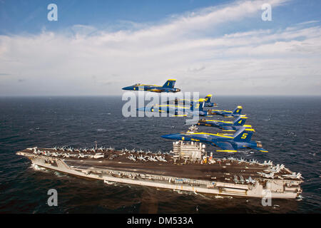 The US Navy Blue Angels flight demonstration squadron flies in the Delta Formation over the aircraft carrier USS George H.W. Bush December 10, 2013 off the Florida coast near Mayport Naval Station. Stock Photo
