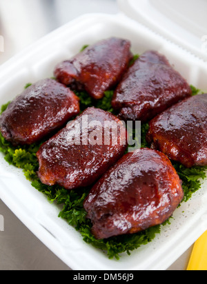 BBQ chicken thighs on a bed of parsley  Stock Photo