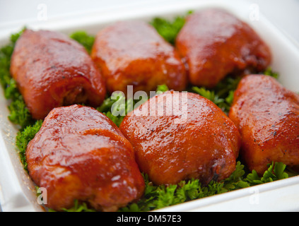 BBQ chicken thighs on a bed of parsley Stock Photo