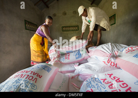 Sacks of rice are sorted in a warehouse in Fenerive Est District, Madagascar, Africa. Stock Photo