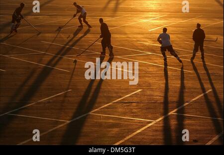 Santa Monica, California, USA. 11th Dec, 2013. Inline skaters playing roller hockey during a game on a parking lot bathed in setting sun light. © Jonathan Alcorn/ZUMAPRESS.com/Alamy Live News Stock Photo