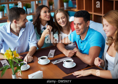 Portrait of large group of teenage friends sitting in cafe Stock Photo