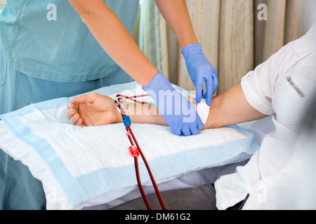 Nurse Starting Dialysis on Patient Stock Photo