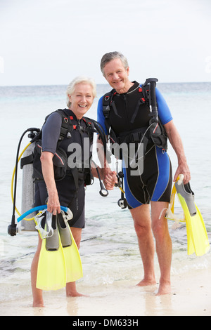 Senior Couple With Scuba Diving Equipment Enjoying Holiday Stock Photo