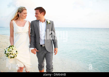 Bride And Groom Getting Married In Beach Ceremony Stock Photo