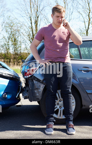 Businessman Making Phone Call After Traffic Accident Stock Photo
