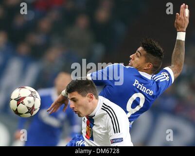 Gelsenkirchen, Germany. 11th Dec, 2013. Schalke's Kevin-Prince Boateng (R) vies for the ball with Basel's Fabian Schaer (L) during the German Bundesliga match between FC Schalke and FC Basel at the stadium in Gelsenkirchen, Germany, 11 December 2013. Photo: FRISO GENTSCH/dpa/Alamy Live News Stock Photo