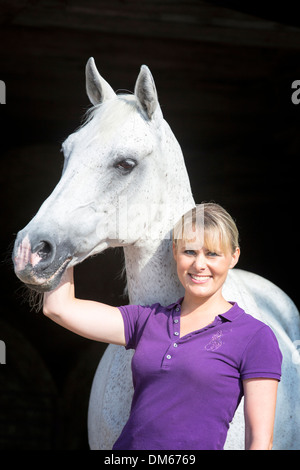 Anglo-Arabian, Anglo-Arab. Portrait of a old gray mare with young woman Stock Photo