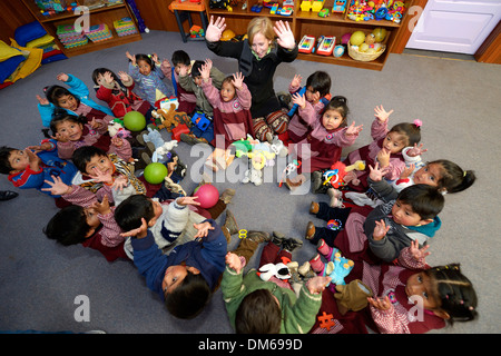 Children sitting on the floor in a circle in a kindergarten, playing, El Alto, Department of La Paz, Bolivia Stock Photo