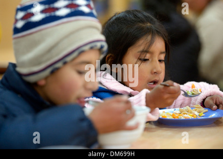 Children eating in the cafeteria of their school, El Alto, Department of La Paz, Bolivia Stock Photo