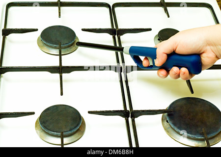 Lighter gas burner ignites the gas stove Stock Photo