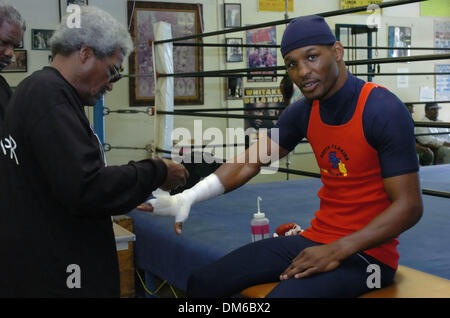Feb 15, 2005; Alhambra, CA, USA; Bernard Hopkin's trainer ANDRE FISHER (L) watches as BOUIE FISHER (2nd L) tapes up World Middleweight Champion BERNARD HOPKINS (40-1-0) as he trains for his historic 20th title defense against Howard 'The Battersea Bomber' Eastman to be held on February 19, 2005 at The Staples Center in Los Angeles. If Hopkins defeats Eastman, he will be the first b Stock Photo