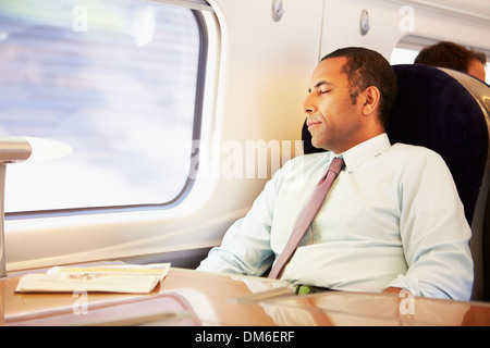 Businessman Resting On Train Stock Photo