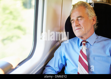 Businessman Resting On Train Stock Photo