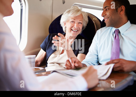 Group Of Businesspeople Having Meeting On Train Stock Photo