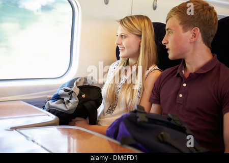 Young Couple Relaxing On Train Journey Stock Photo