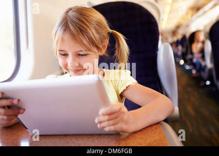 Girl Using Digital Tablet On Train Stock Photo