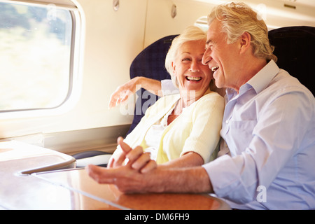 Senior Couple Relaxing On Train Journey Stock Photo