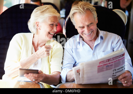 Senior Couple Relaxing On Train Journey Stock Photo