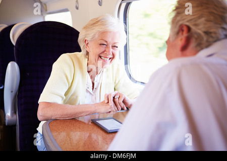 Senior Couple Relaxing On Train Journey Stock Photo