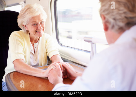 Senior Couple Relaxing On Train Journey Stock Photo