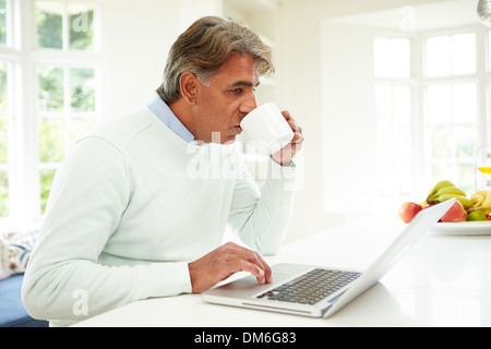 Senior Indian Man Using Laptop At Home Stock Photo