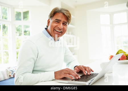 Senior Indian Man Using Laptop At Home Stock Photo