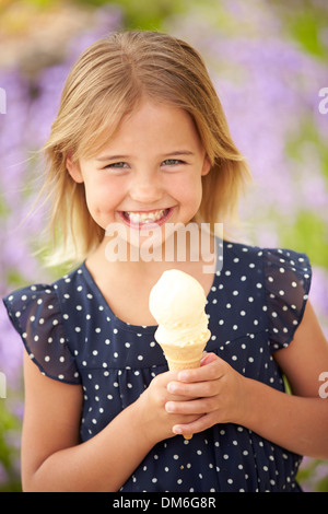 Young Girl Eating Ice Cream Outdoors Stock Photo