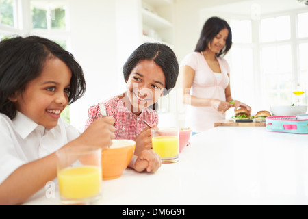 Mother Making School Packed Lunches For Children Stock Photo