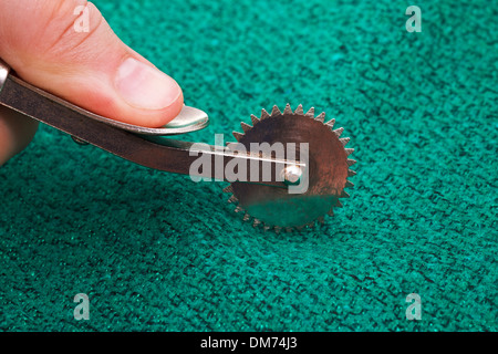 Sewing pattern on fabric, tracing wheel, tracing paper, sewing equipment  Stock Photo - Alamy