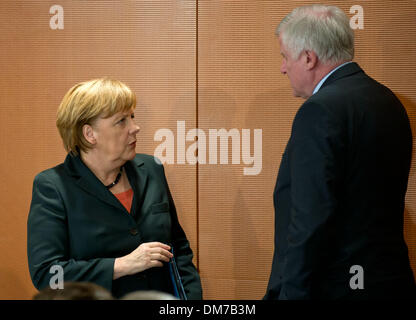 Berlin, Germany. 12th Dec, 2013. German Chancellor Angela Merkel (CDU) talks to CSU chairman and Bavarian premier Horst Seehofer at the beginning of the Ministerial Conference of the German States in the Federal Chancellery in Berlin, Germany, 12 December 2013. Photo: Tim Brakemeier/dpa/Alamy Live News Stock Photo