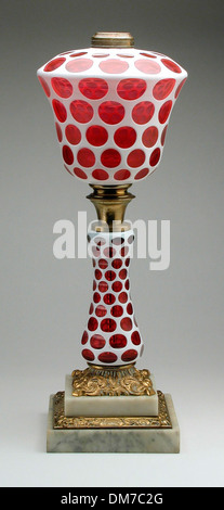 A functional and decorative kerosene table lamp, designed for lighting before the widespread use of electricity. The lamp reflects 19th-century home decor. Stock Photo