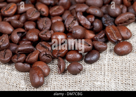 many roasted coffee beans on sacking close up Stock Photo