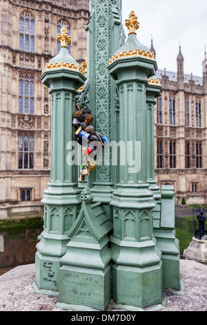 Love locks on a green and gold lamppost outside the Houses of Parliament, London, UK Stock Photo
