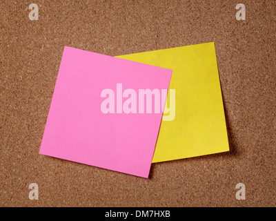 two reminder sticky notes on cork board, empty space for text Stock Photo