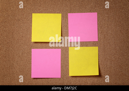 four reminder sticky notes on cork board, empty space for text Stock Photo