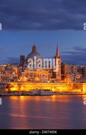 Malta, Valletta, skyline with St. Paul's Anglican Cathedral and Carmelite Church at dusk from Sliema Stock Photo