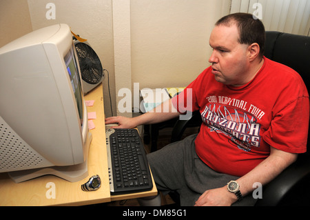 An autistic man lost his job of many years doing data entry with a local police department after he lost funds for a job coach. Stock Photo