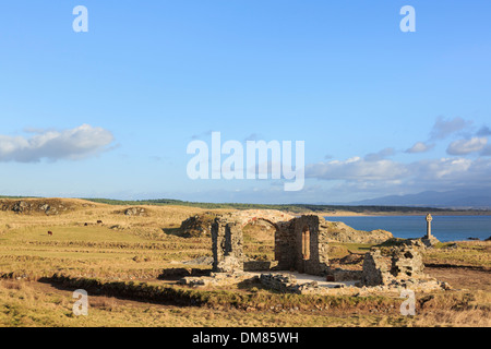 Historic 16th century ruins of St Dwynwen's church with Celtic cross on Ynys Llanddwyn Island Isle of Anglesey, North Wales, UK Stock Photo